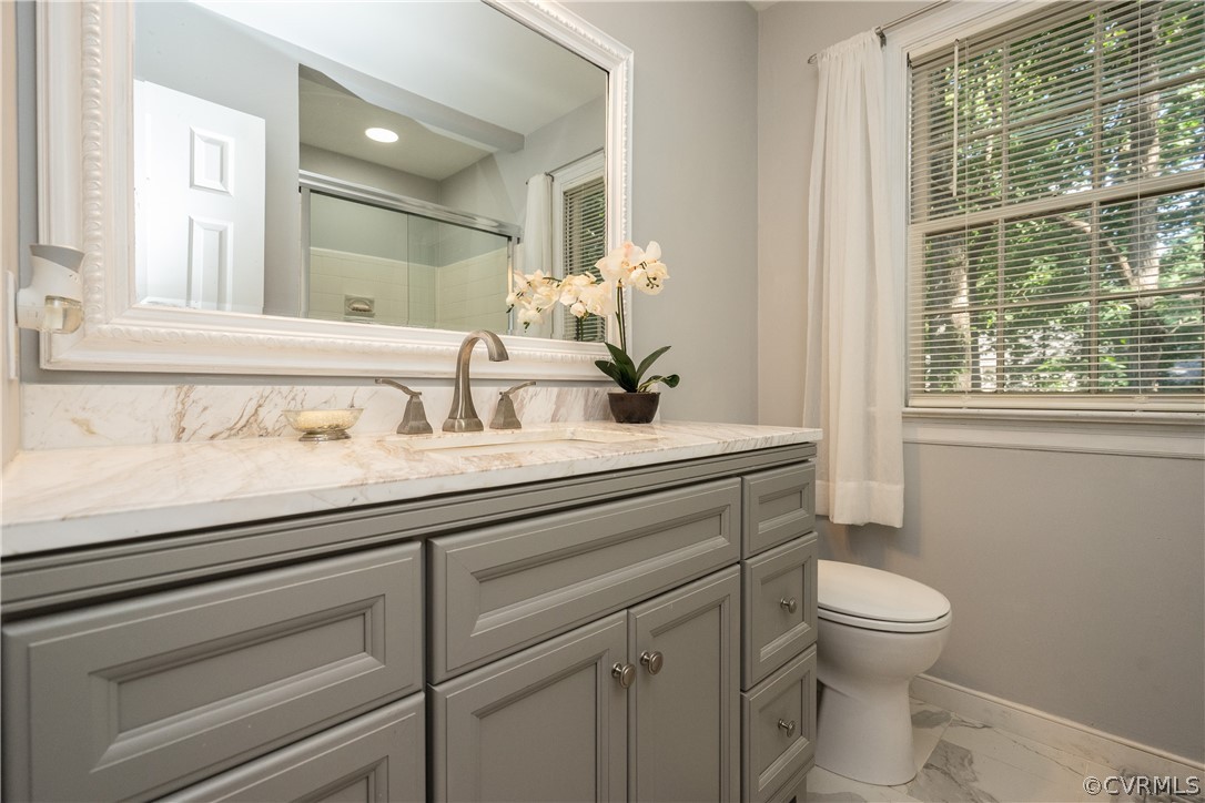 11330 Poplar Ridge Road Chesterfield, VA 23236 - Photo 20 of 32 a bathroom with a toilet a sink and a mirror