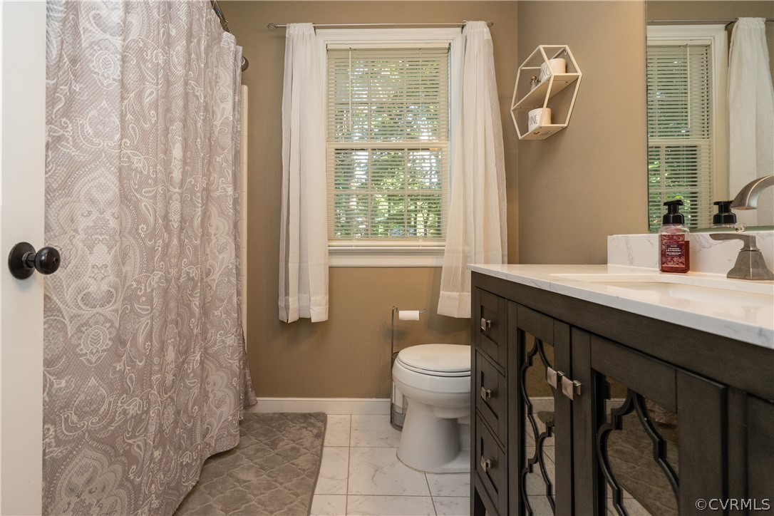 11330 Poplar Ridge Road Chesterfield, VA 23236 - Photo 24 of 32 a bathroom with a sink a toilet and shower
