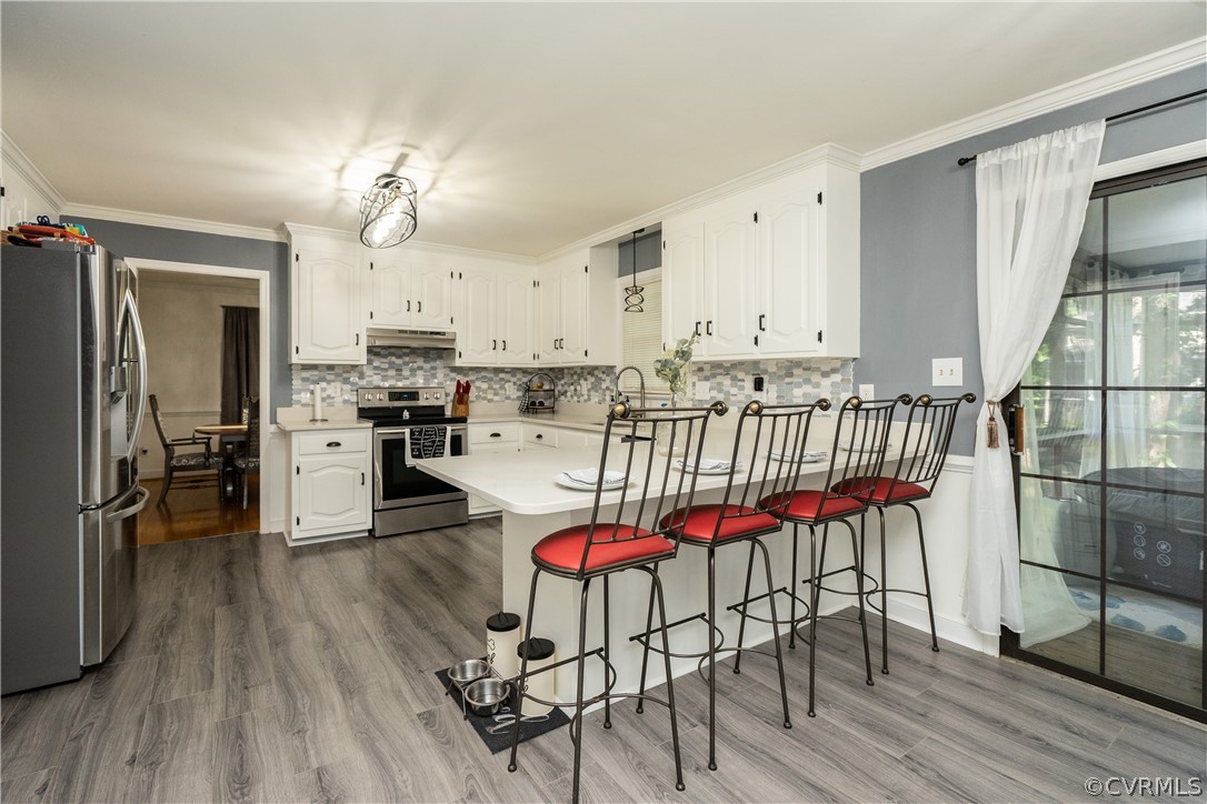 11330 Poplar Ridge Road Chesterfield, VA 23236 - Photo 8 of 32 an open kitchen with granite countertop wooden floor stainless steel appliances and dining table
