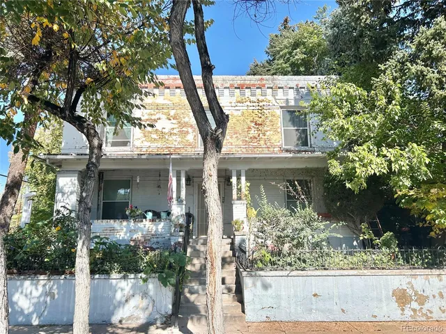 front view of a house with a tree