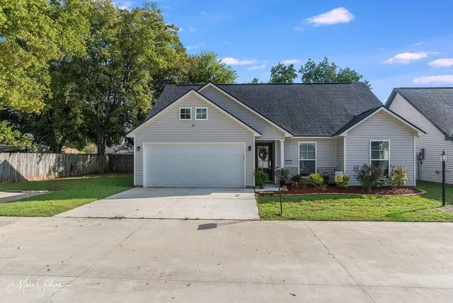 a front view of house with yard and green space