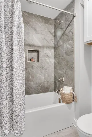 a bathroom with a bathtub and shower