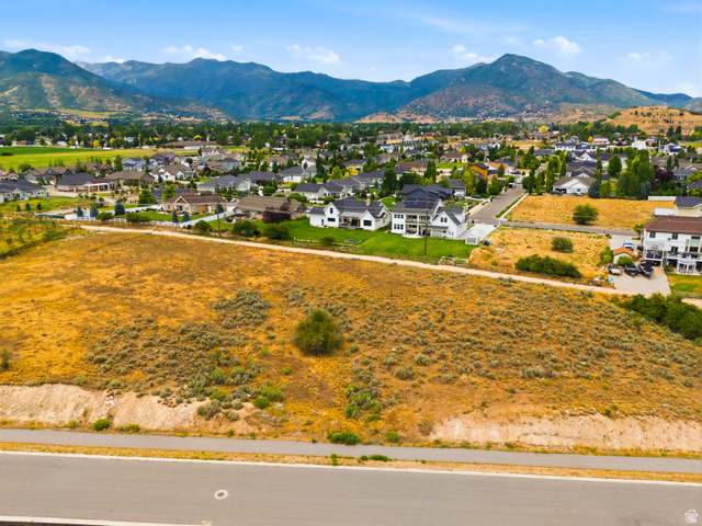 574 South Fox Den Road, Unit 3 Midway, UT 84049 - Photo 39 of 45 Expansive undeveloped parcel featuring natural vegetation and a visible paved road frontage