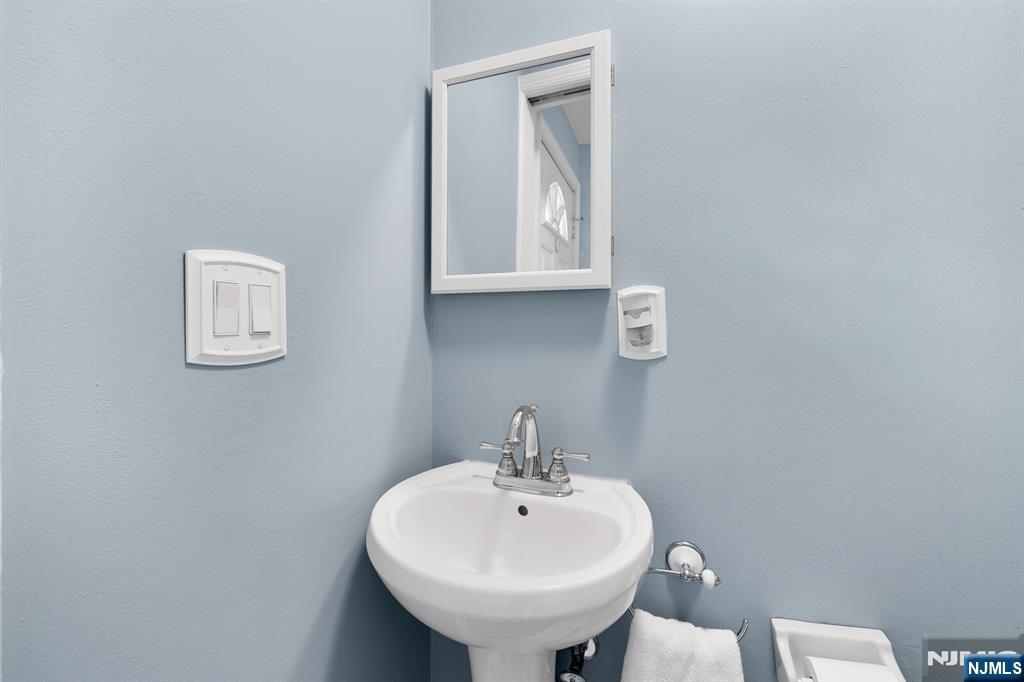 106 Maple Street Rutherford, NJ 07070 - Photo 24 of 50 a bathroom with a sink a mirror and a toilet