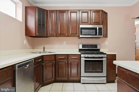 a kitchen with stainless steel appliances granite countertop a stove microwave and oven