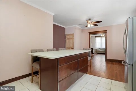 a kitchen with a sink cabinets and wooden floor