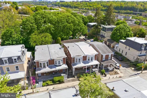an aerial view of residential house with parking