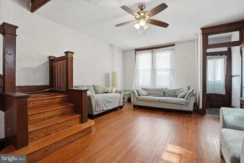 a living room with furniture and wooden floor
