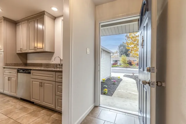 a view of a kitchen with microwave and windows