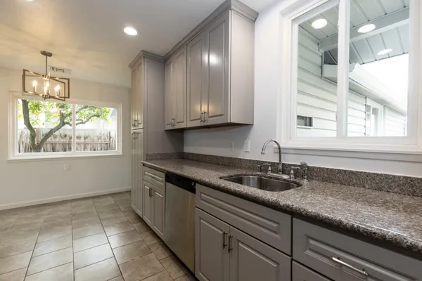 a kitchen with granite countertop a sink and a window