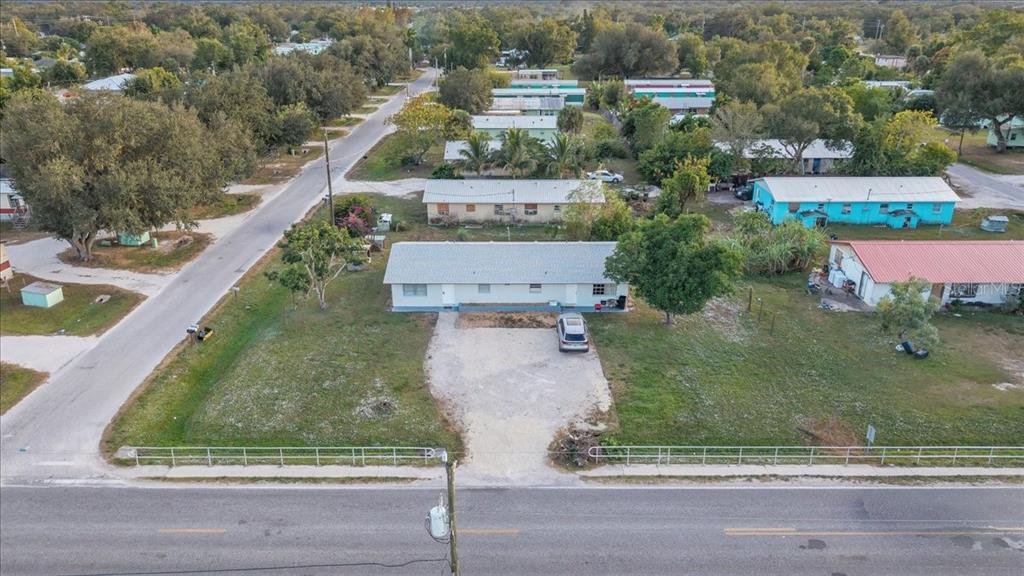 1099 Hargrave Street Arcadia, FL 34266 - Photo 1 of 1 an aerial view of residential houses with outdoor space and parking
