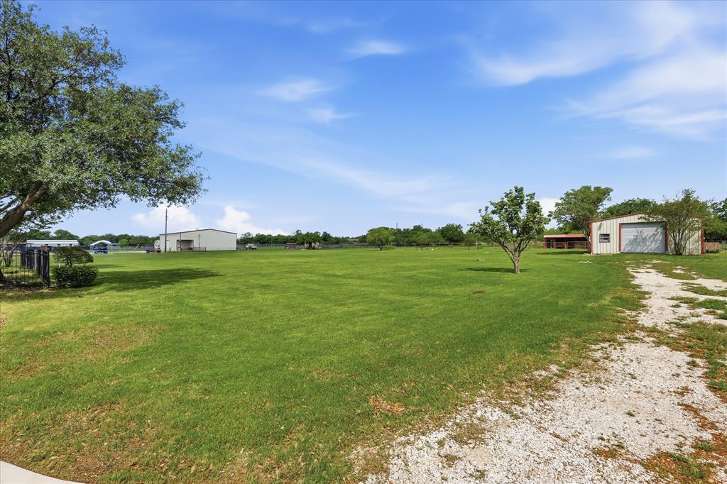 211 Bayne Road Haslet, TX 76052 - Photo 25 of 29 a backyard of a house with lots of green space