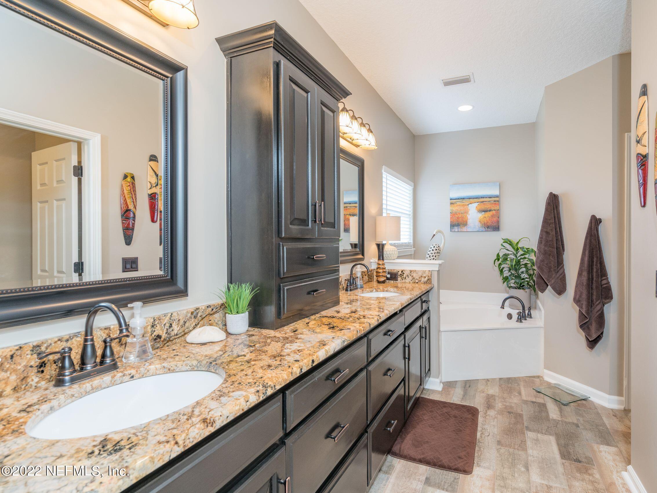 54476 Wildlife Way Callahan, FL 32011 - Photo 17 of 35 a bathroom with a granite countertop double vanity sink and mirror