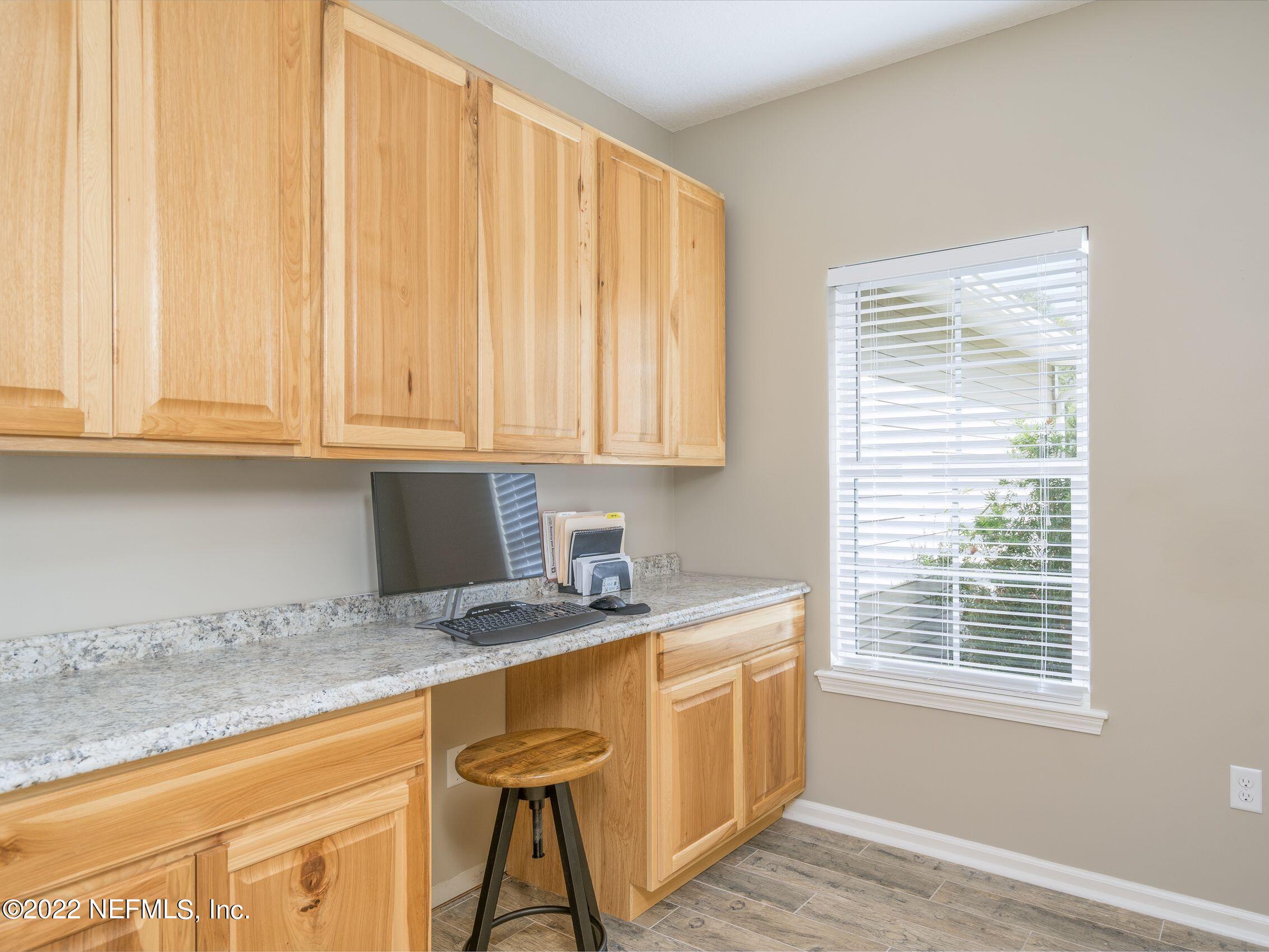 54476 Wildlife Way Callahan, FL 32011 - Photo 19 of 35 a kitchen with stainless steel appliances granite countertop wooden cabinets a sink and dishwasher