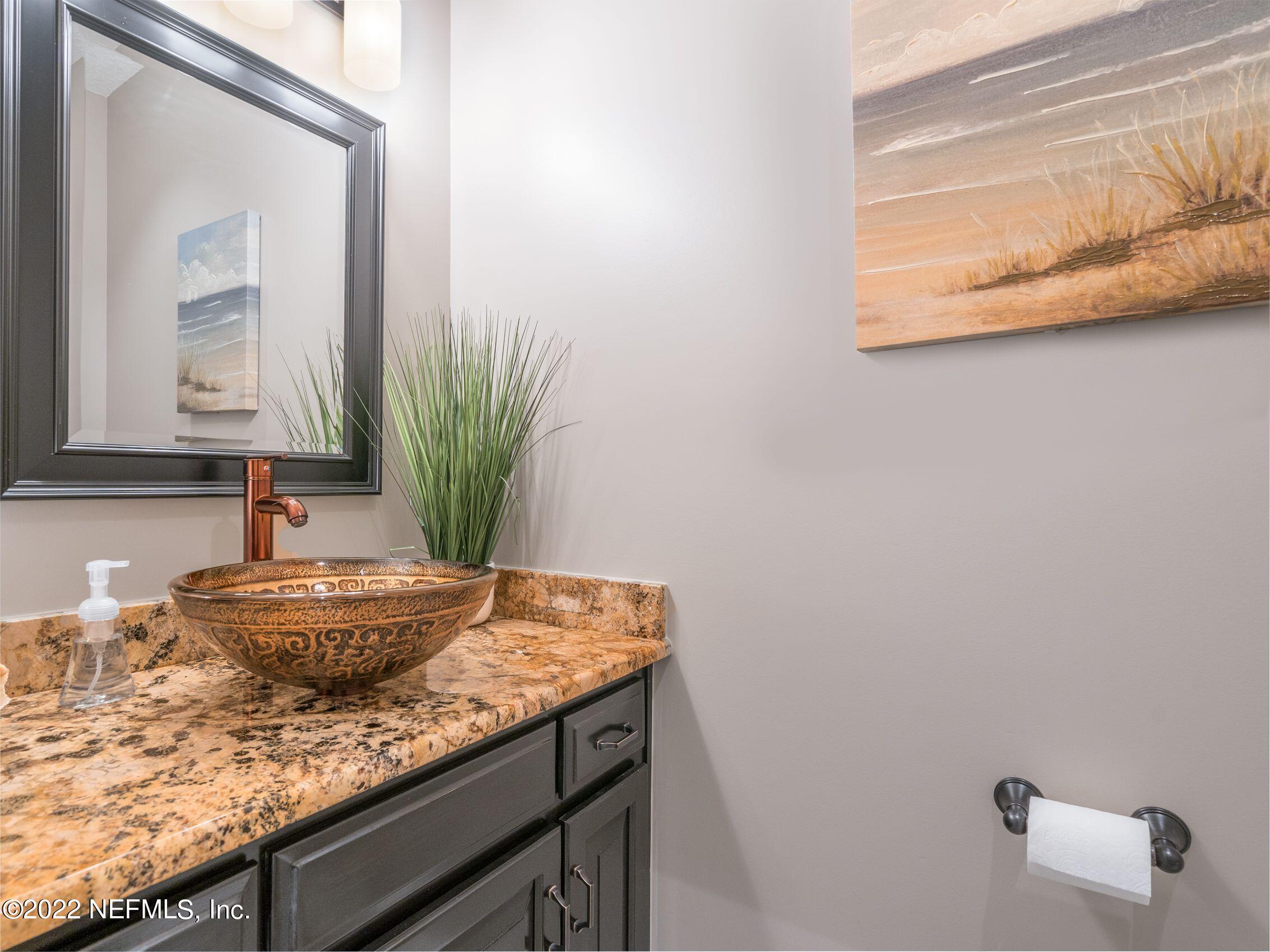 54476 Wildlife Way Callahan, FL 32011 - Photo 20 of 35 a bathroom with a granite countertop sink and a mirror