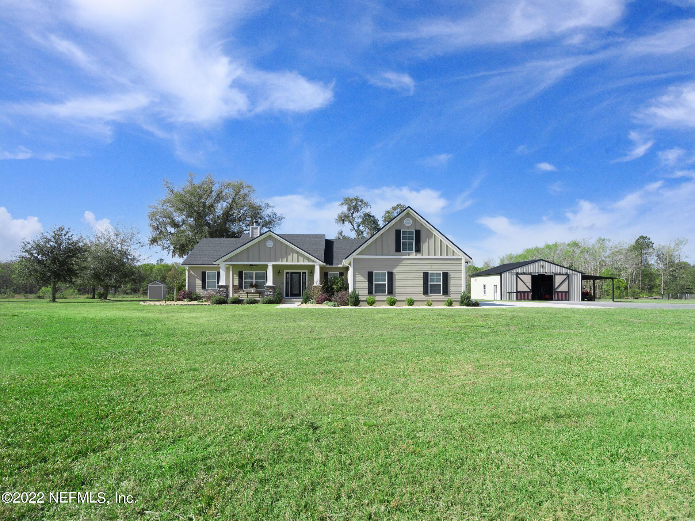 54476 Wildlife Way Callahan, FL 32011 - Photo 2 of 35 a front view of a house with a garden