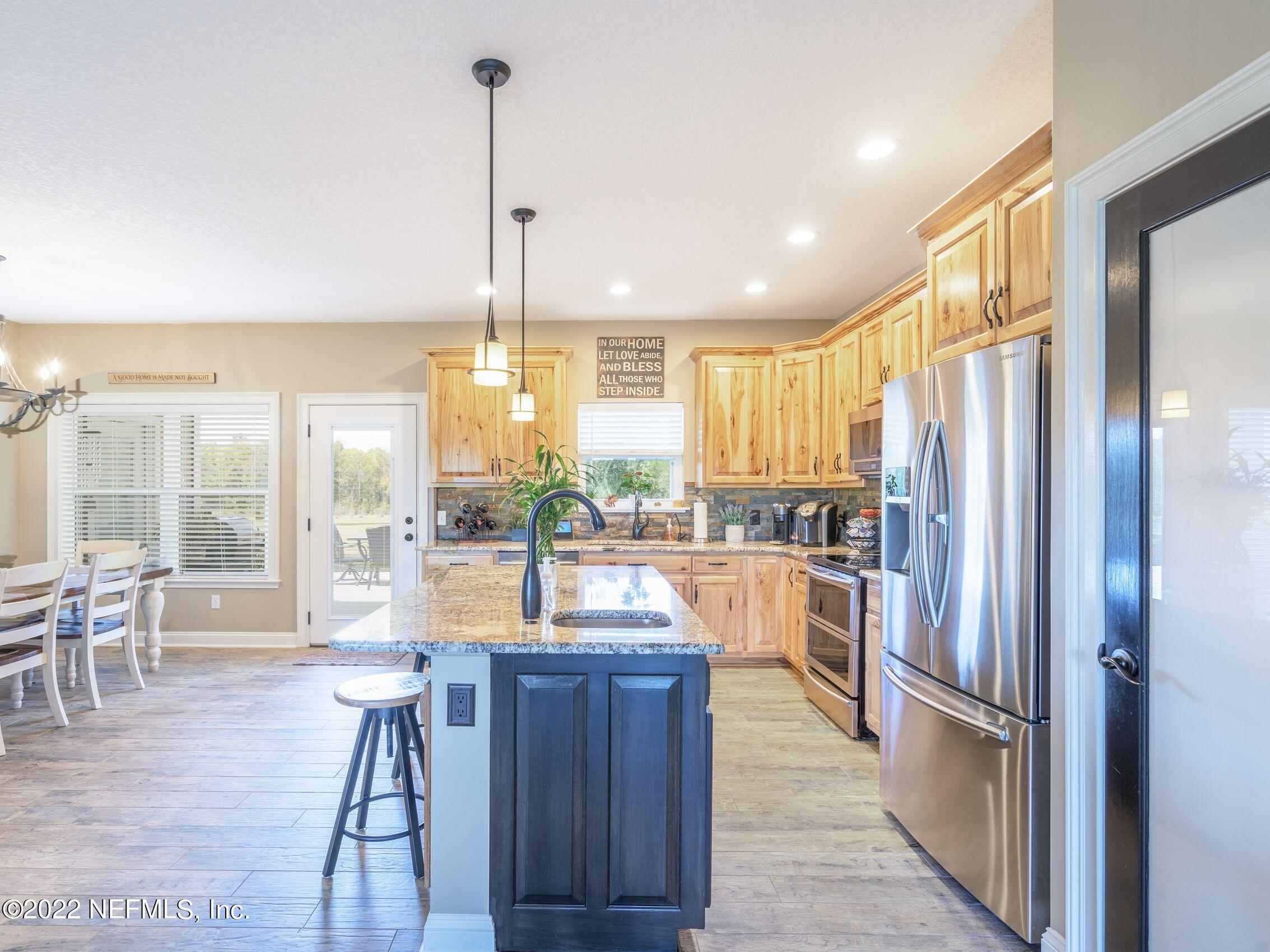 54476 Wildlife Way Callahan, FL 32011 - Photo 9 of 35 a kitchen with a large window and stainless steel appliances