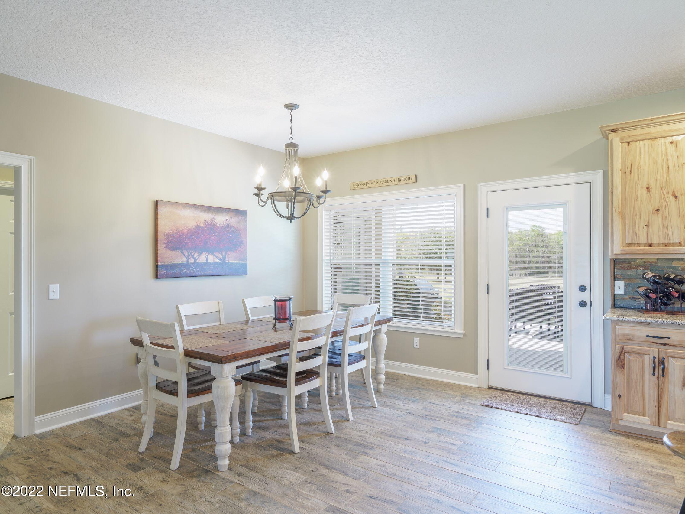 54476 Wildlife Way Callahan, FL 32011 - Photo 10 of 35 a view of a dining room with furniture window and wooden floor