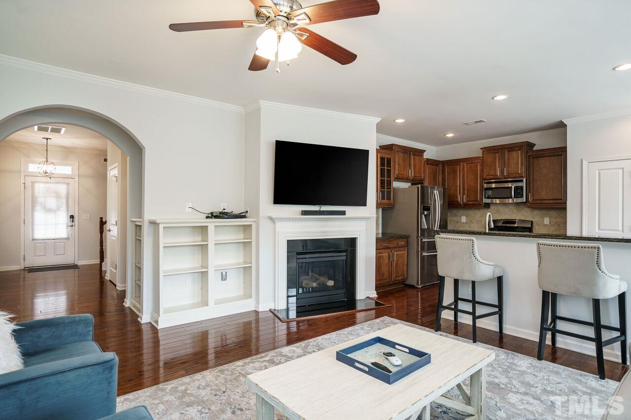 1308 Rodessa Run Raleigh, NC 27607 - Photo 8 of 31 a living room with furniture a fireplace and a flat screen tv