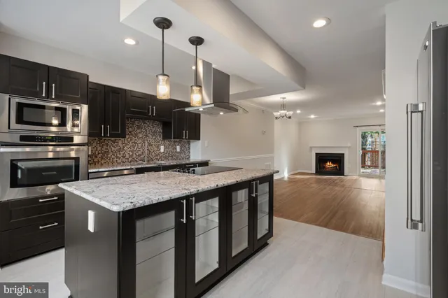 a kitchen with a sink a microwave a stove and refrigerator