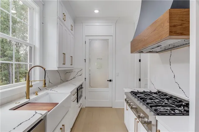 a kitchen with a sink stove and refrigerator