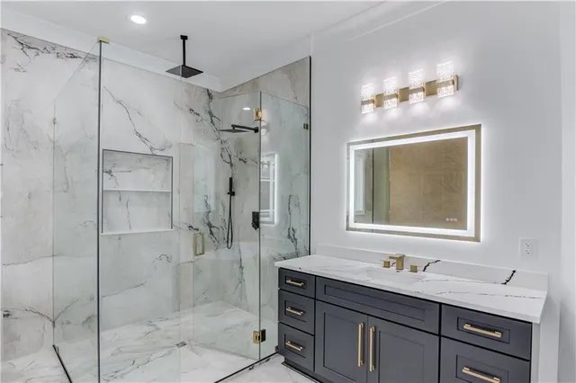 a bathroom with a shower sink and mirror