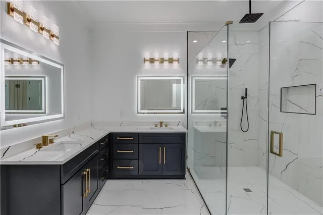 a bathroom with a bathtub shower sink and mirror