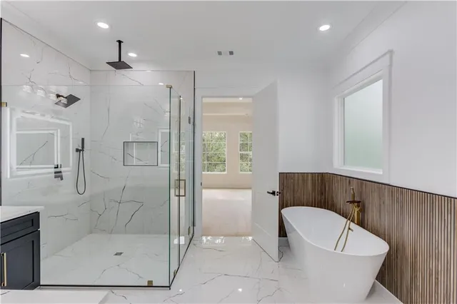 a bathroom with a sink toilet a mirror and shower