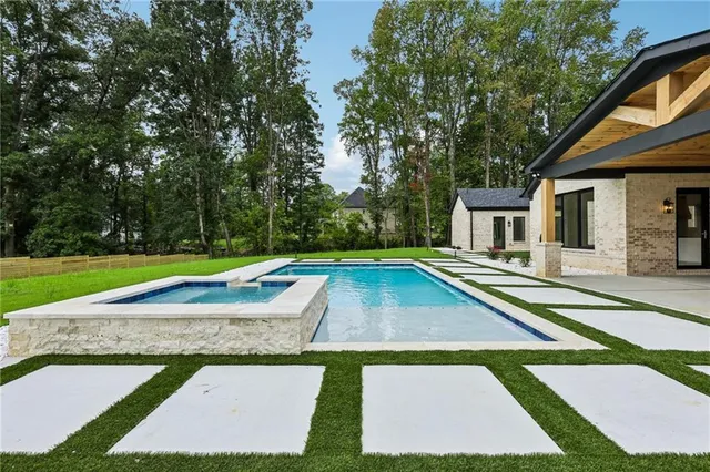 a view of pool with brick walls