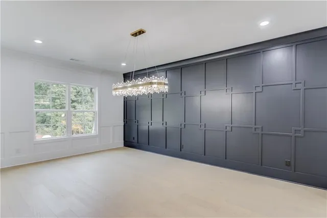 an empty room with a projector and a window