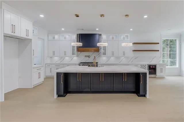 a kitchen with stainless steel appliances a sink stove and cabinets