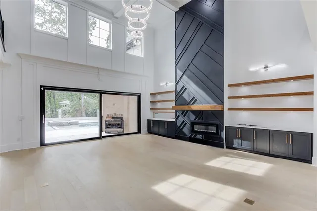 a view of an empty room with a fireplace and a window