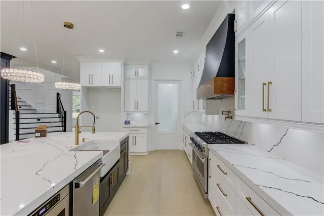 a kitchen with a sink stove and cabinets