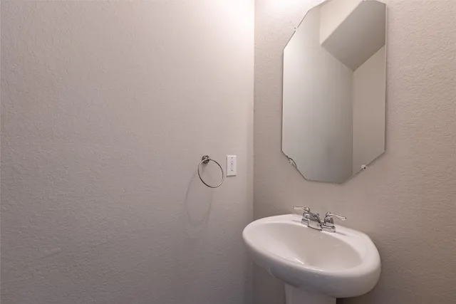 a bathroom with a sink and mirror
