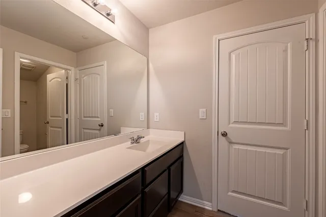 a bathroom with a double vanity sink and a mirror