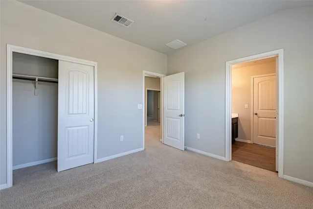 a view of an empty room and closet area