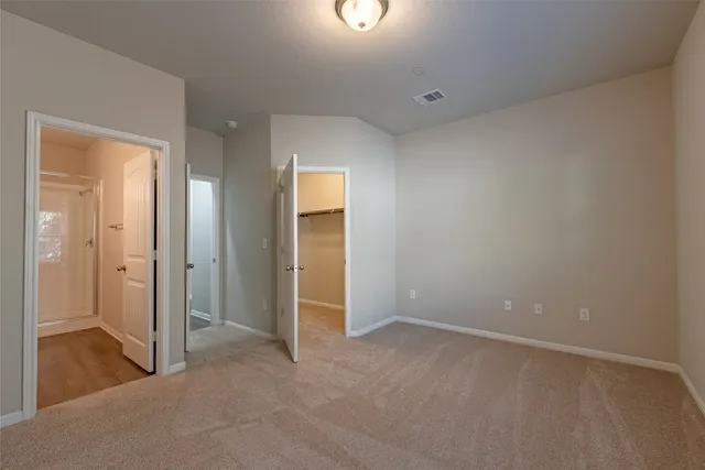 an empty room with closet and mirror