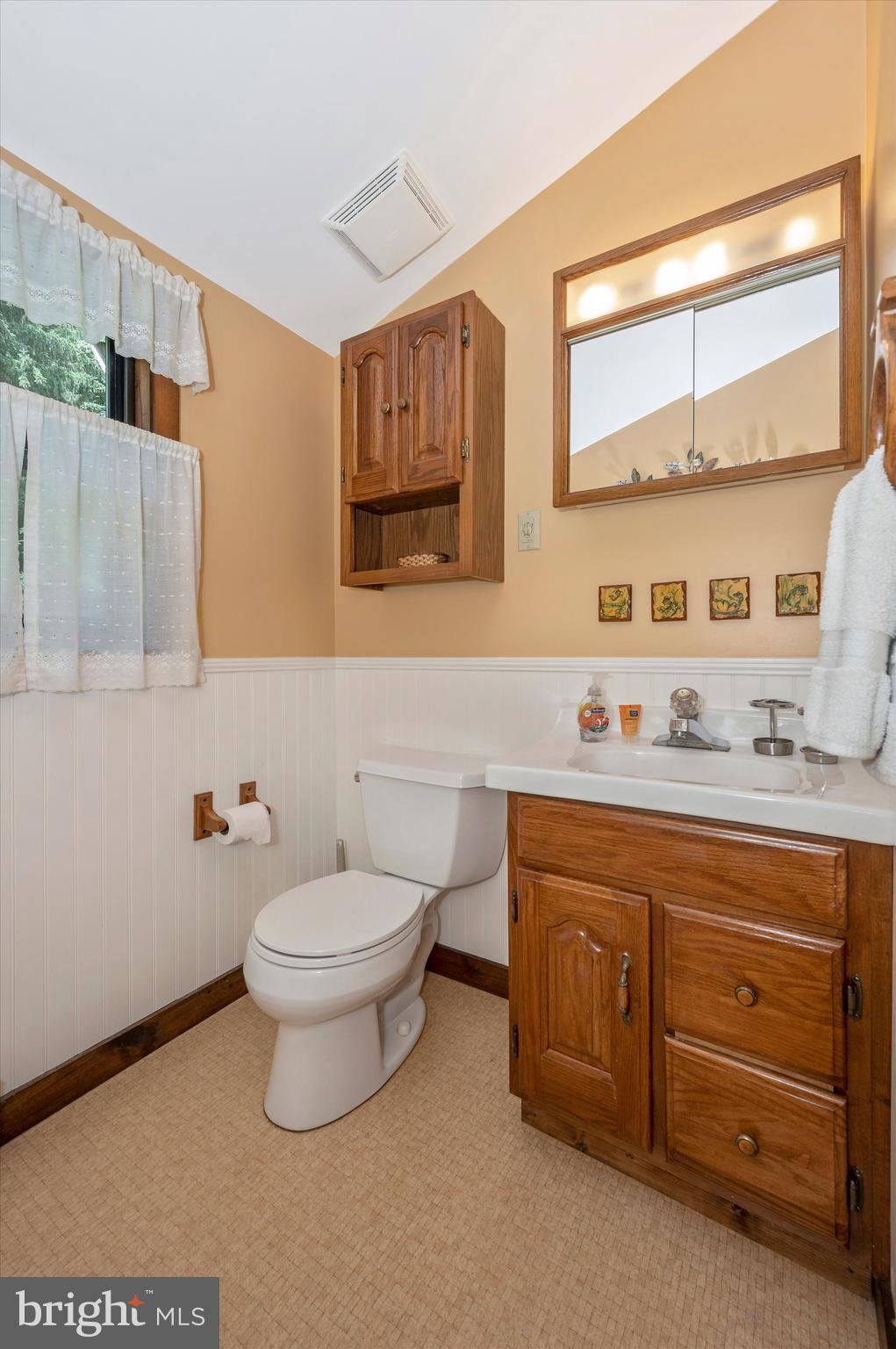 9301 Hamburg Road Frederick, MD 21702 - Photo 33 of 57 a bathroom with a granite countertop toilet sink and mirror
