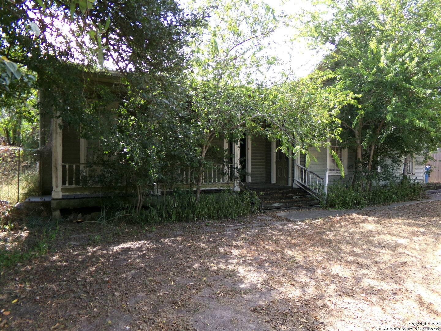 a view of a house with a tree in the background