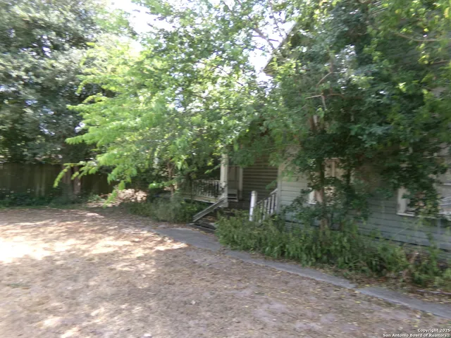 a view of a tree in the middle of a yard