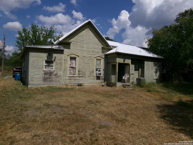 a view of a house with a yard and garage