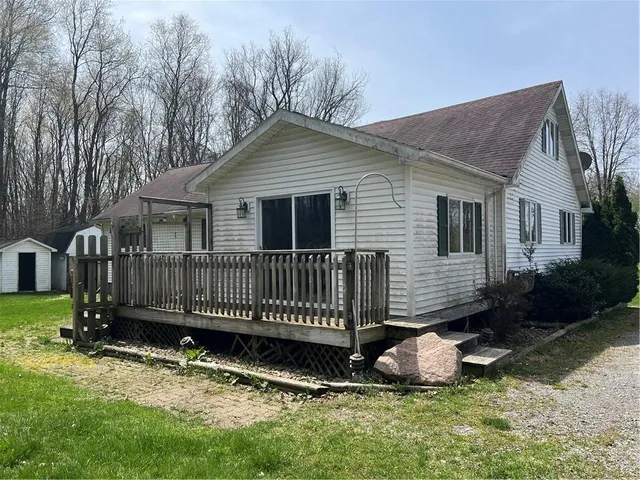a view of a house with a yard and deck