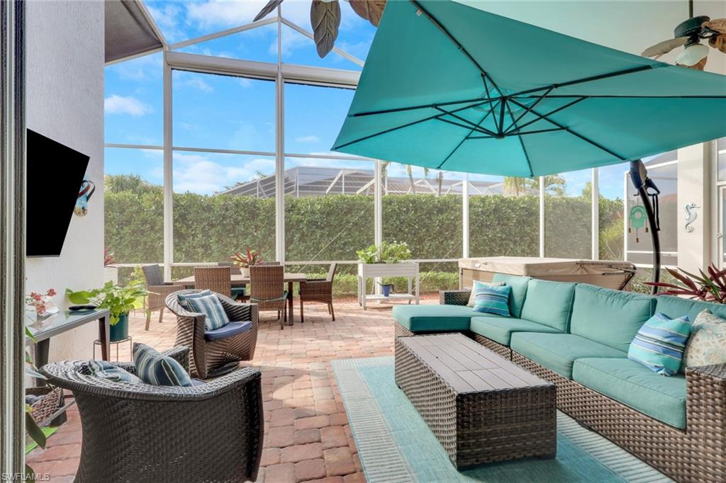 View of patio featuring an outdoor hangout area, a sunroom, glass enclosure, and outdoor dining space