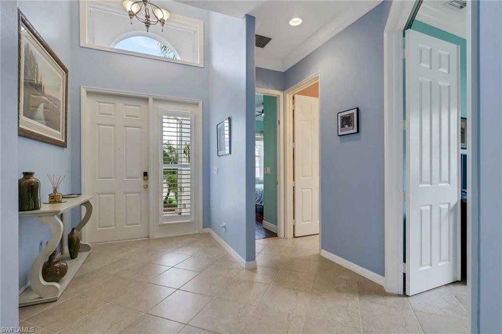 9348 Sun River Way Estero, FL 33928 - Photo 11 of 50 Foyer with plenty of natural light, recessed lighting, a chandelier, and light tile patterned floors