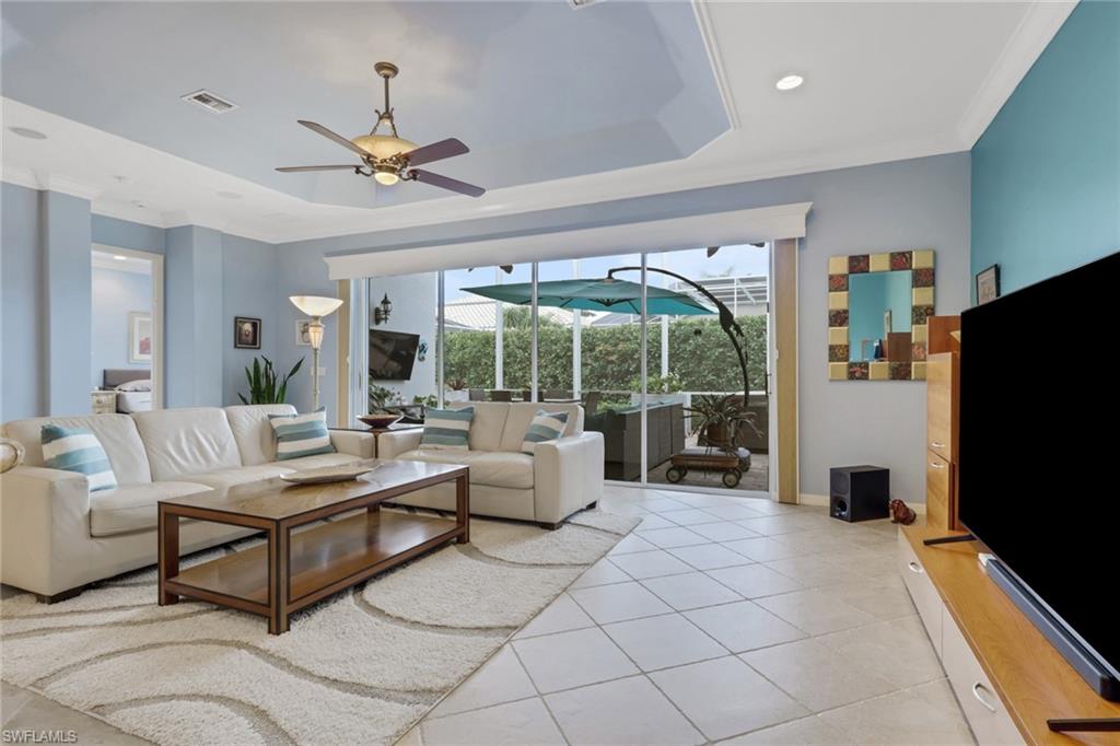 9348 Sun River Way Estero, FL 33928 - Photo 19 of 50 Living area featuring ornamental molding, a sunroom, a raised ceiling, ceiling fan, and light tile patterned flooring