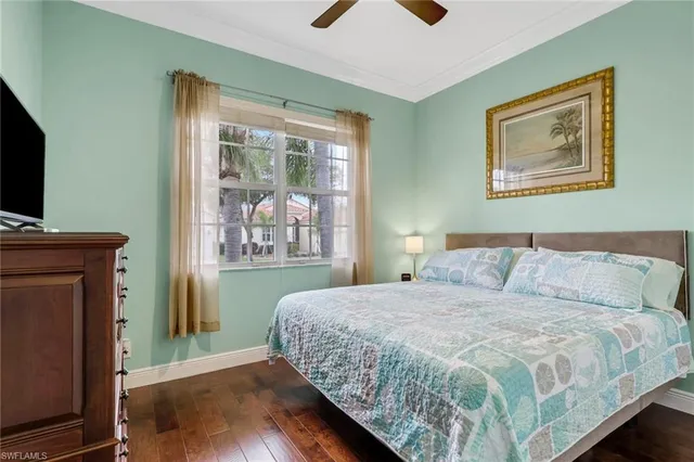 a bedroom with a bed and a flat tv screen