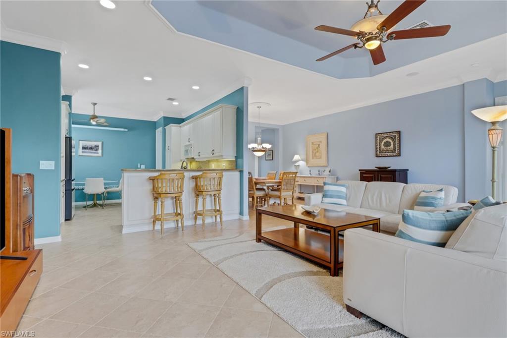 9348 Sun River Way Estero, FL 33928 - Photo 21 of 50 Living area with ceiling fan, a chandelier, recessed lighting, ornamental molding, and light tile patterned floors