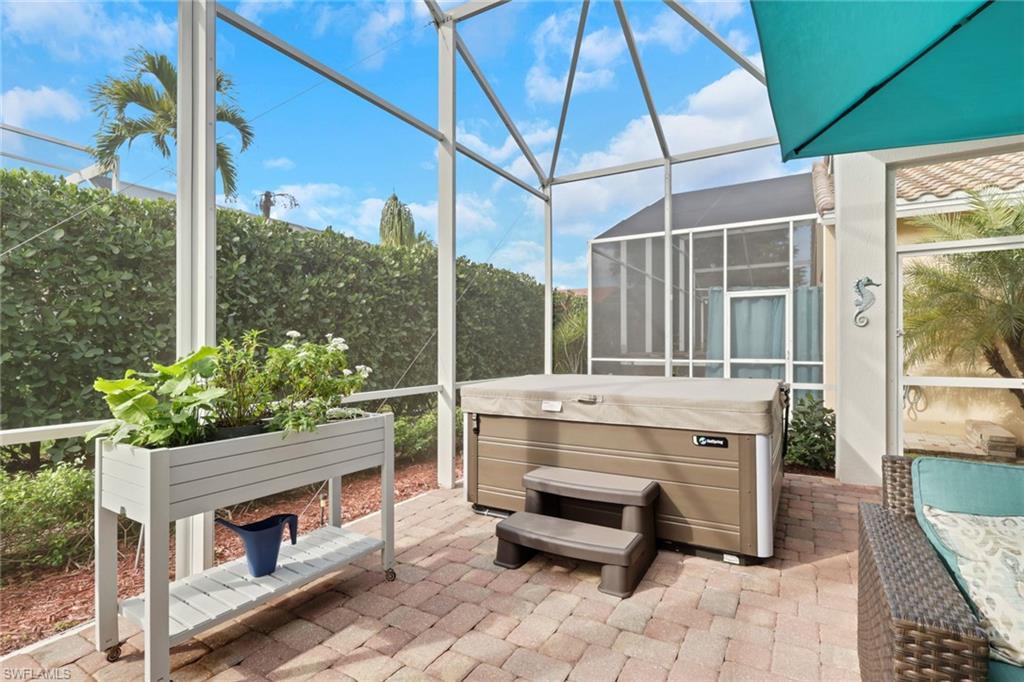 9348 Sun River Way Estero, FL 33928 - Photo 3 of 50 Sunroom / solarium featuring a patio area and a jacuzzi