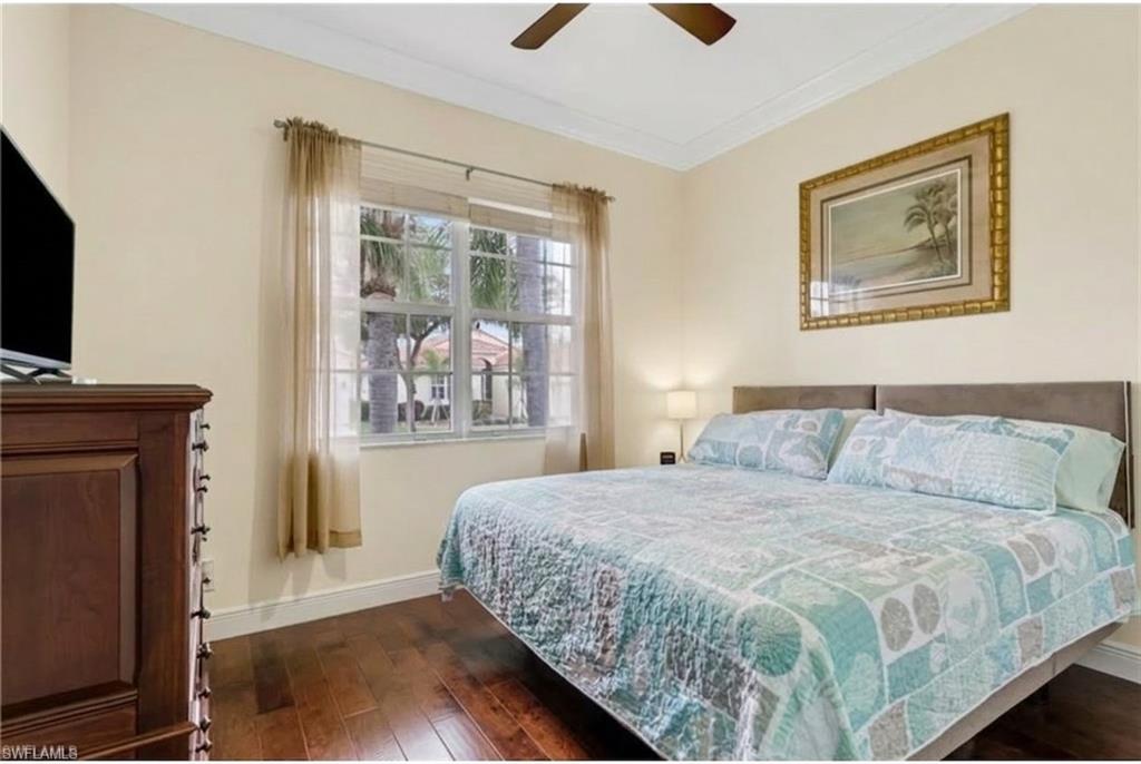9348 Sun River Way Estero, FL 33928 - Photo 31 of 50 Bedroom featuring dark wood-style flooring, ceiling fan, and ornamental molding