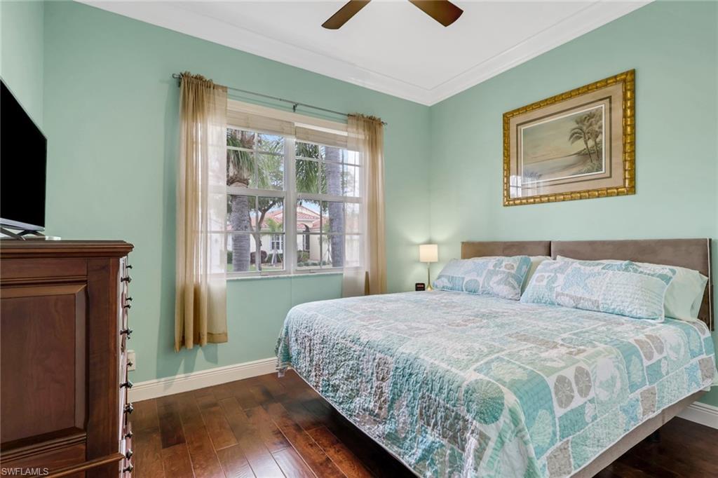 9348 Sun River Way Estero, FL 33928 - Photo 32 of 50 Bedroom featuring dark wood-style floors, crown molding, and ceiling fan
